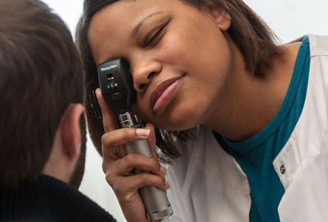 doctor examining student's eye