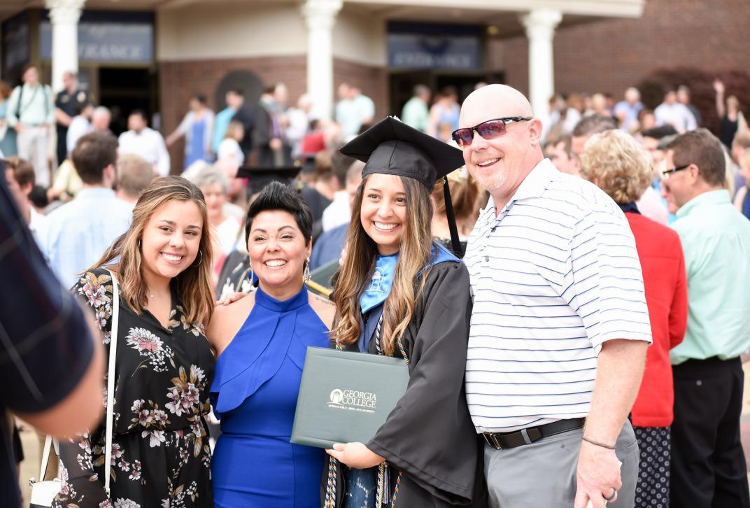 Family posing with Georgia College graduate