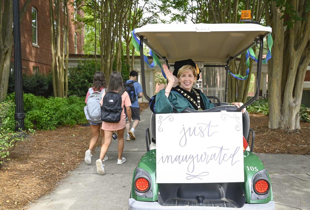 President Cox riding on a golf cart