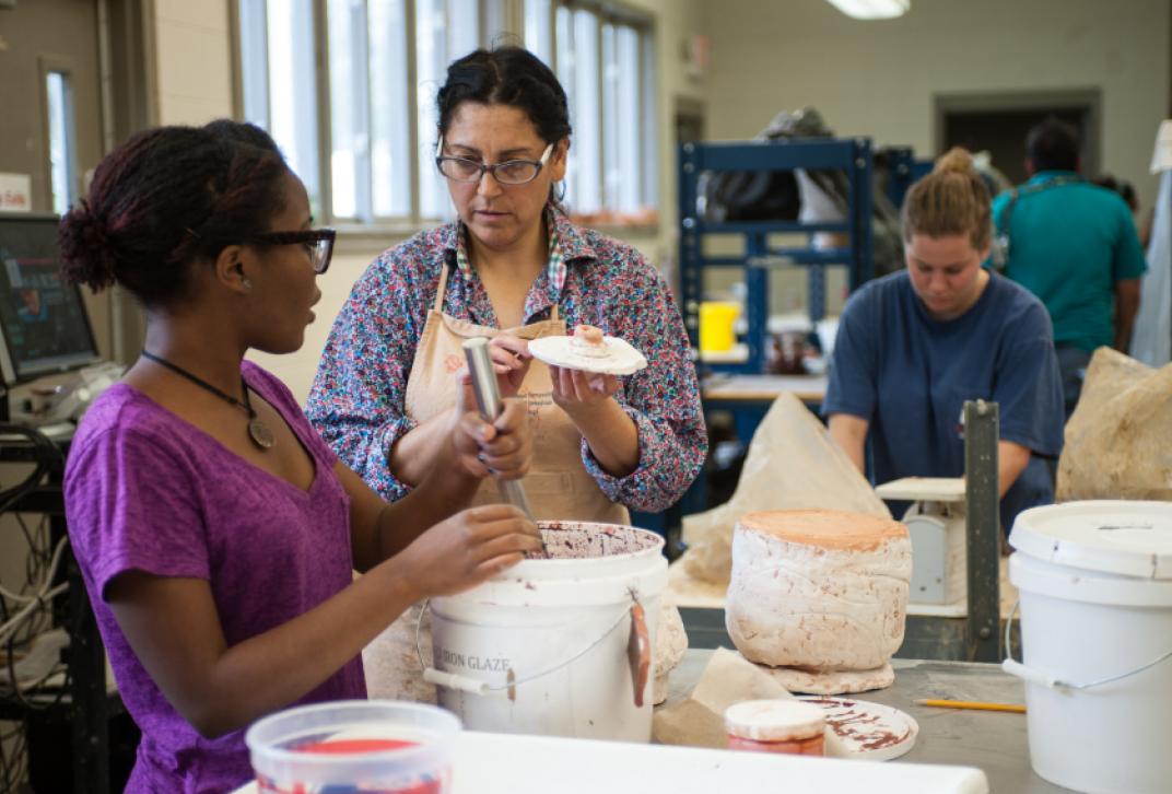 faculty and student working on an art project