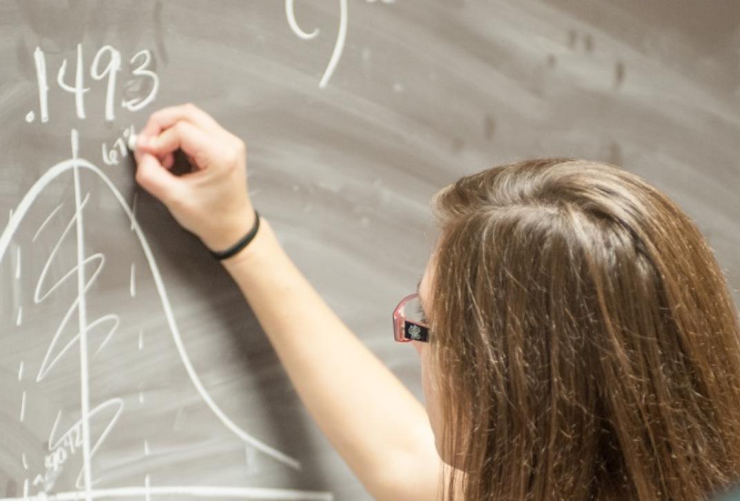 math student at chalk board