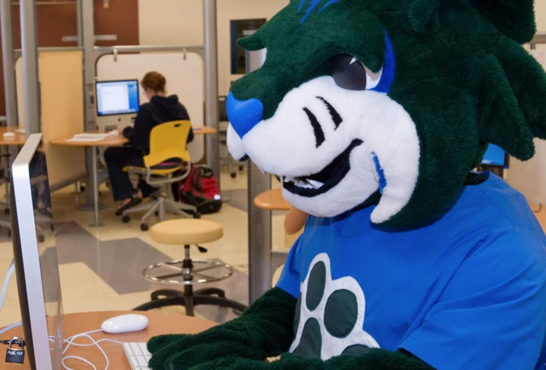 mascot registering at computer in lab