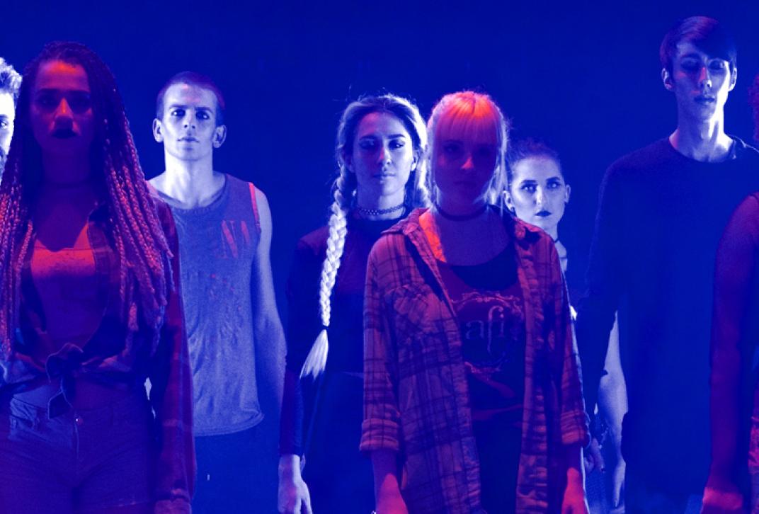 students on stage in blue lighting