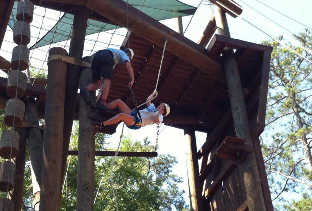 students climb ropes course