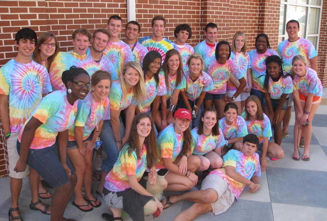 students pose in tie dye shirts