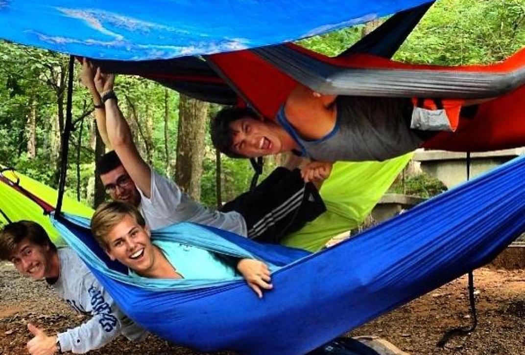 students pose in hammocks