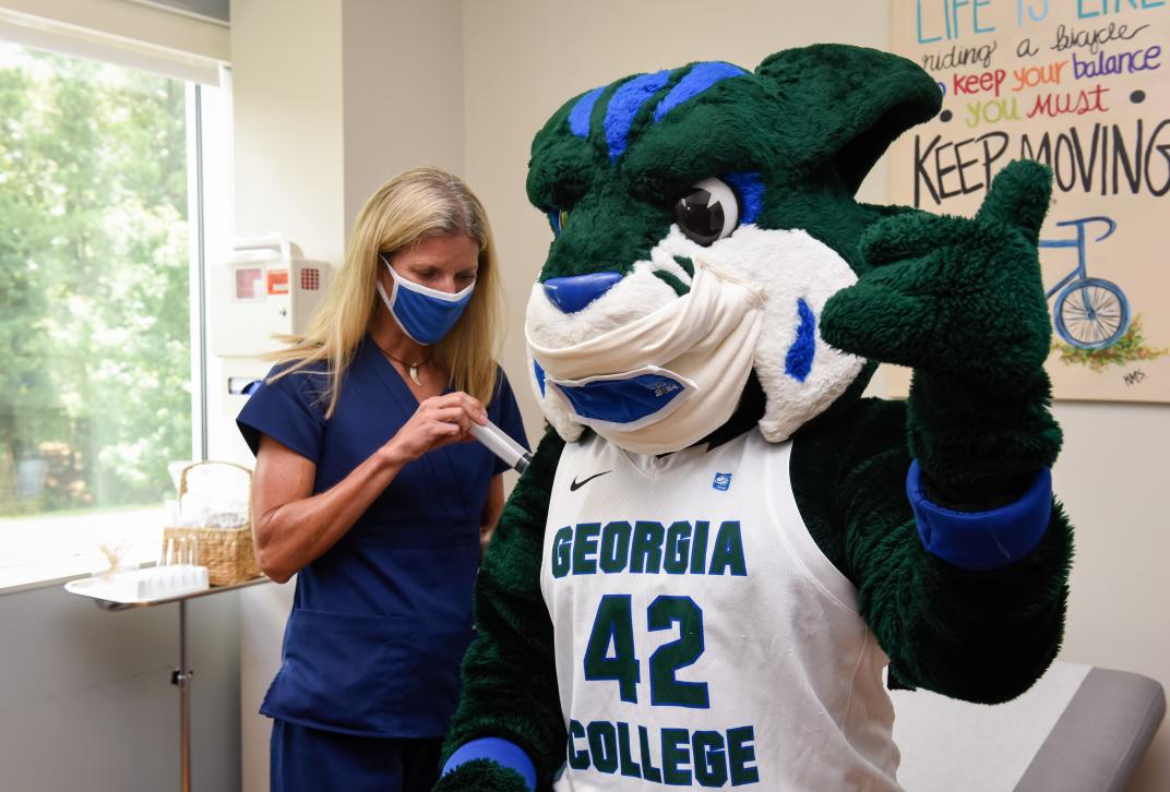 GC mascot Thunder getting vaccinated at the Student Health Clinic