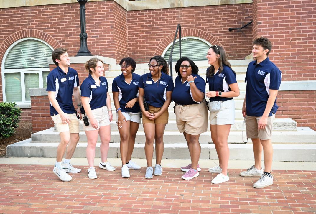 Orientation leaders stand outside Atkinson Hall