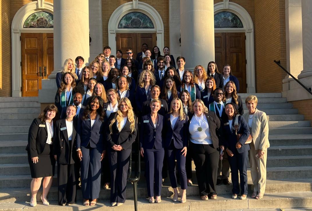 Ambassadors pose with President Cox after a formal event.