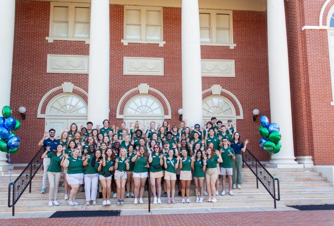 Ambassadors pose with paws up at a preview day.