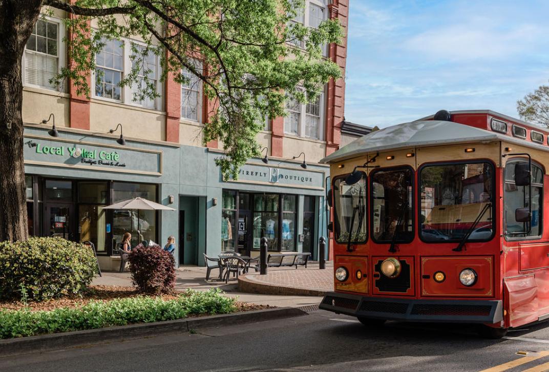 A red trolley stopped in downtown Milledgeville