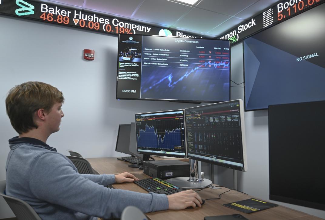 A student working at the financial portal in the Bobcat Trading Room