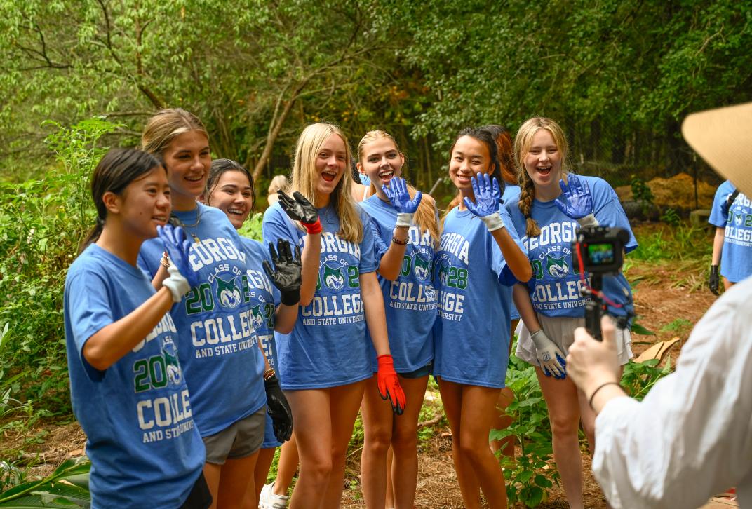 GCSU students pose for a photo outside while volunteering