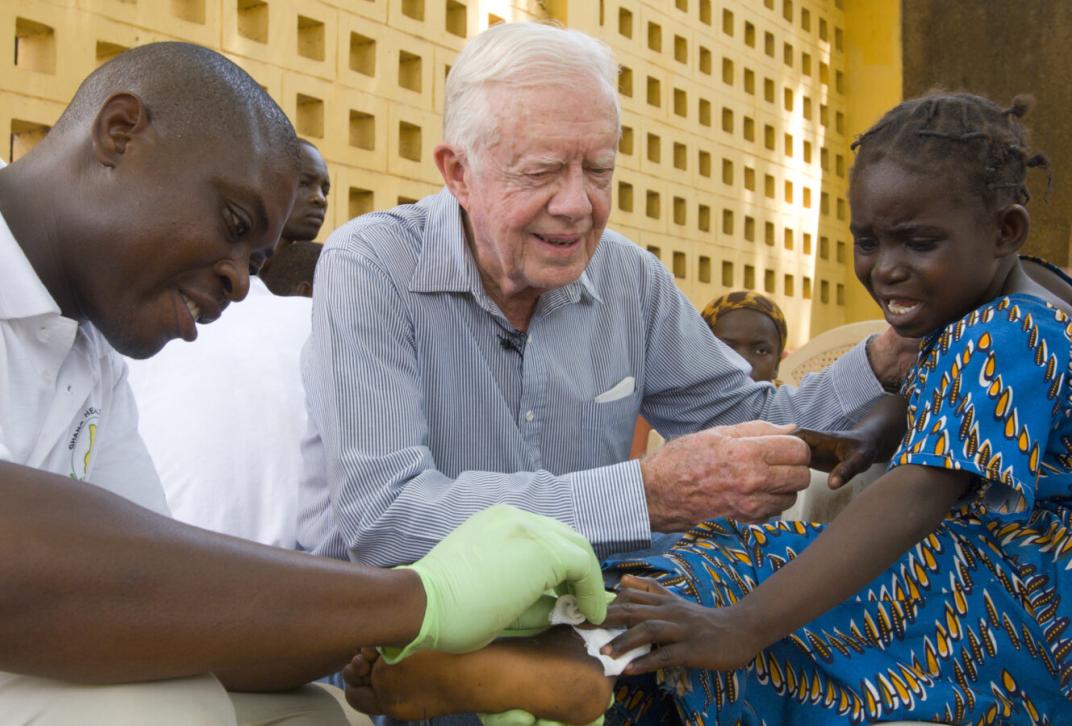 Former President Jimmy Carter comforts six-year-old Ruhama Issah at Savelugu Hospital in Ghana