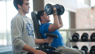 Two GC students using dumbells at WRC