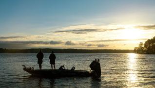2 People on a boat fishing in the lake