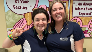Two Community Assistants pose for a photo