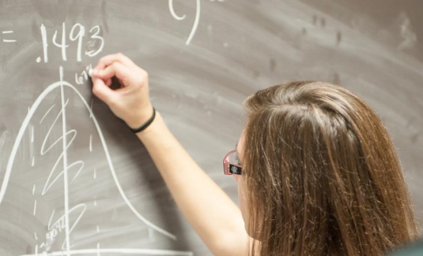 math student at chalk board