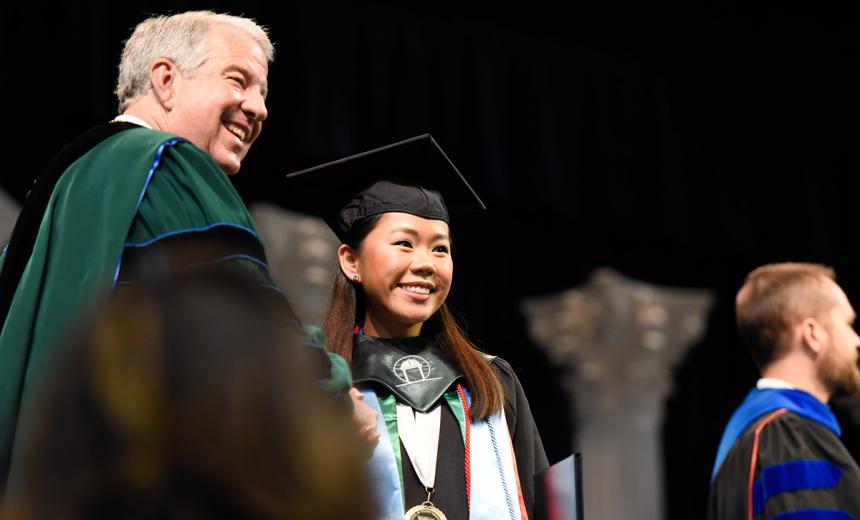 Student Receiving Diploma from University President