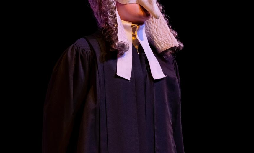 A menacing looking judge in wig and mask delivers his verdict
