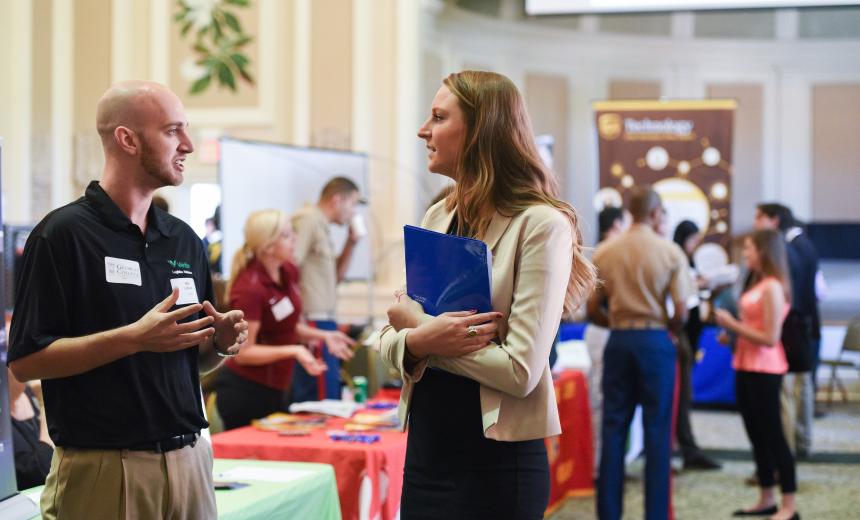 A student networks with an employer