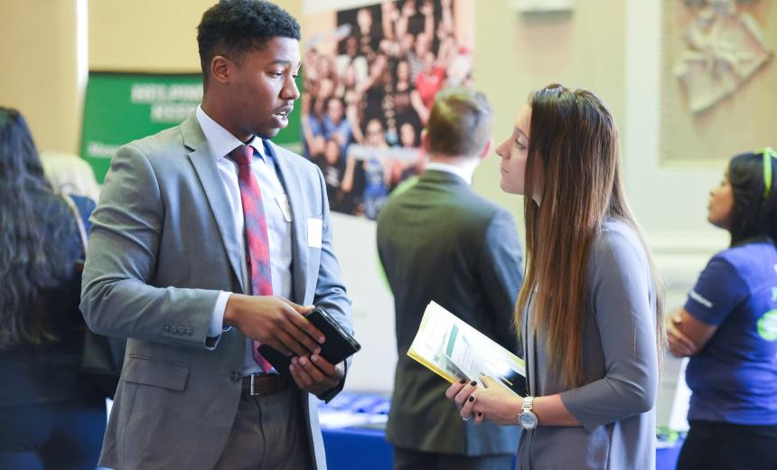 A student networks with an employer