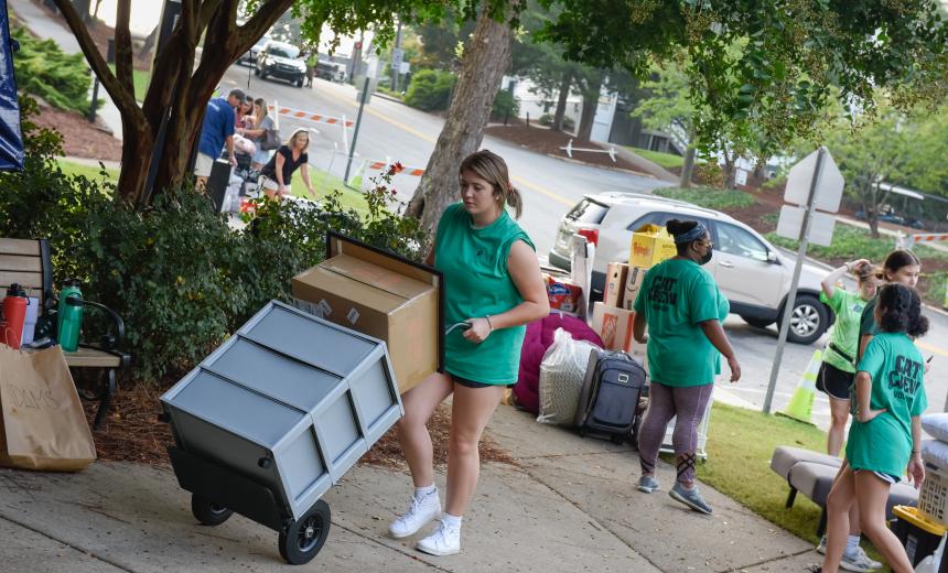 Cat Crew volunteers assisting in new student move-in at Adams Hall.