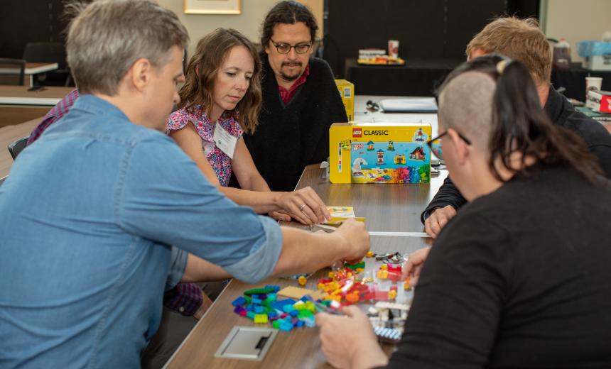 Image of new faculty assembling Legos during New Faculty Orientation