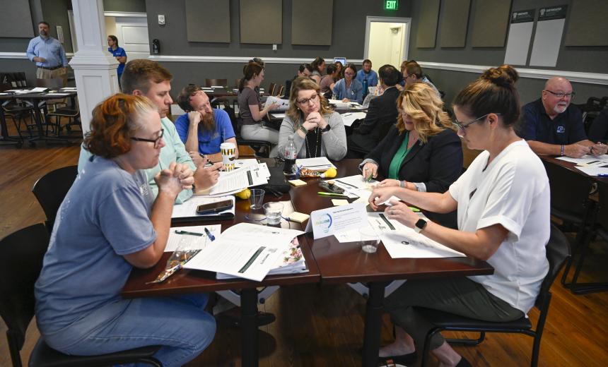 A group of employees discussing the future of Georgia College at a table top session