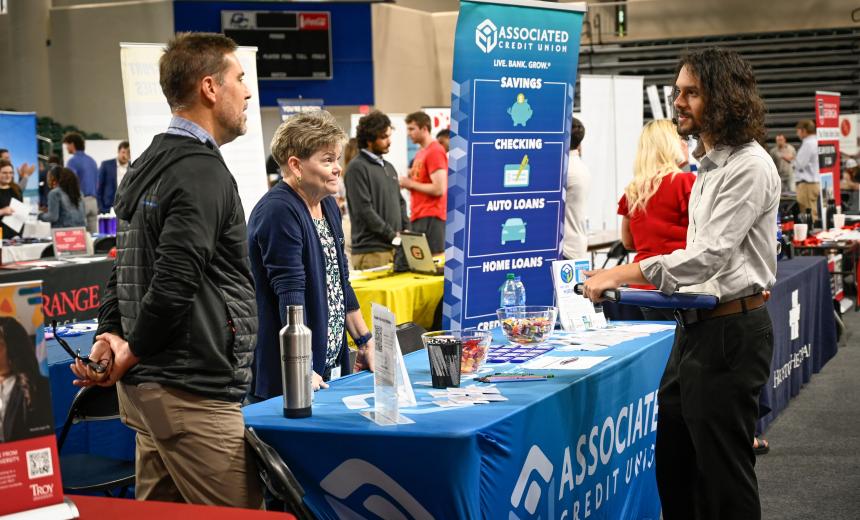 A student talks to a recruiter at job fair