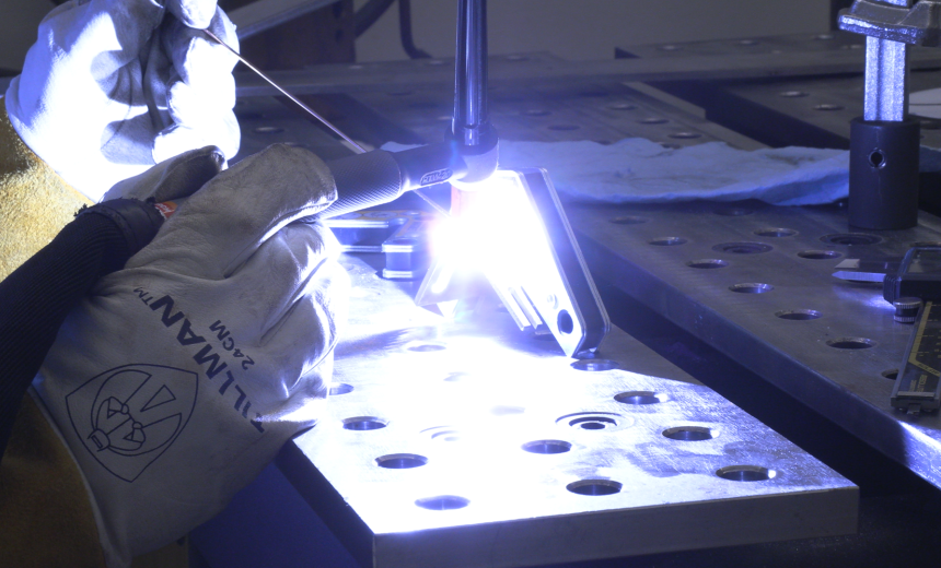 A welder is welding some metal together