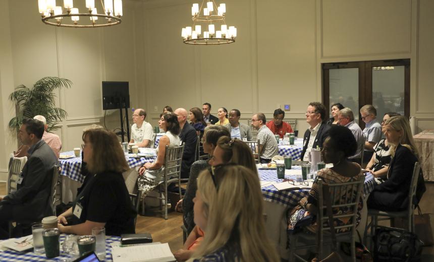group of academic leadership sitting listening to speaker