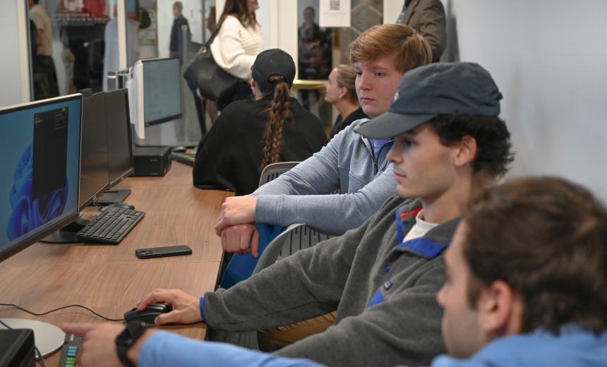 Students collaborating together on a computer in a lab