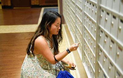 student checking for mail in mailroom