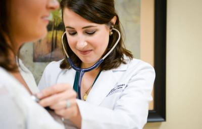 student using stethoscope on patient