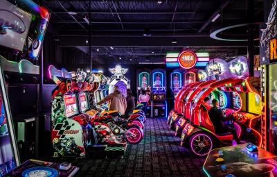 Video games line the inside of a dark room