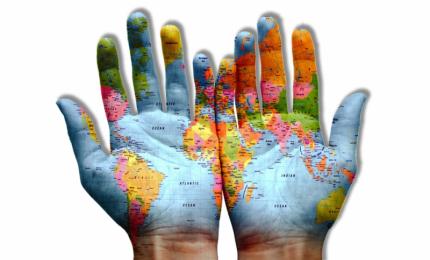 world map superimposed on open hands