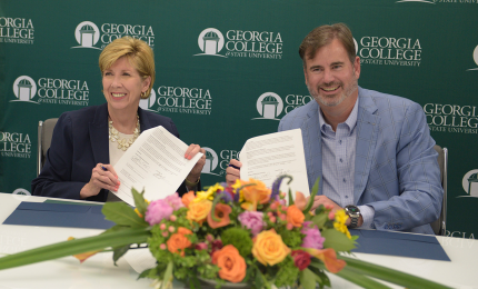 President Cathy Cox and Fouts Bros President and CEO Scott Edens sign the MOU.