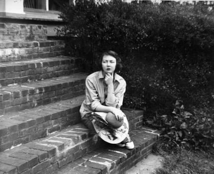 Flannery O’Connor sitting on the steps of her home in Milledgeville, Ga. in 1959 (Floyd Jillson/Atlanta Journal-Constitution, via Associated Press, courtesy of the filmmakers)