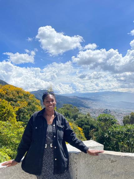 Amara Tennessee standing in front of a valley in Colombia