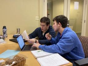 two students tutoring at desk